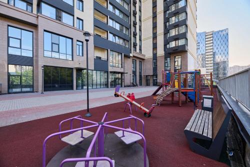 a playground in a city with a building at Five Business-class rooms in R-house near Mega Center Almaty in Almaty