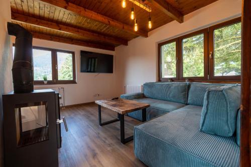 a living room with a couch and a table at Chata Ostravice pod Smrkem in Ostravice