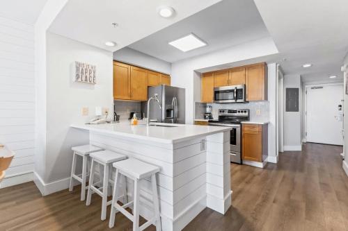 a kitchen with a white counter top and wooden cabinets at Harbourgate Resort Charming Marina Front Unit 122 in Myrtle Beach