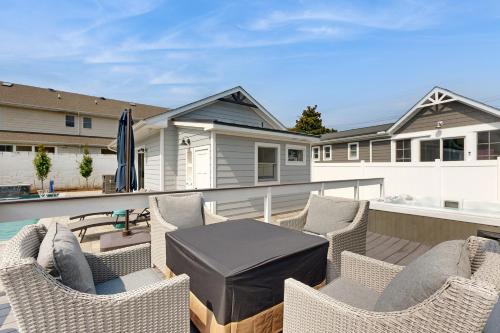 a patio with chairs and a table on a balcony at Rehoboth Beach --- 37484 Washington Street in Rehoboth Beach