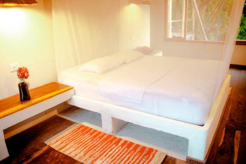 a white bed in a room with a window at Casa Mul-Kala - Palomino - Guajira in Palomino