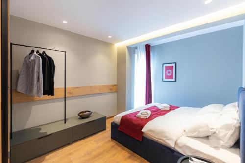 a bedroom with a large bed and a window at Prado Apartments in Pristina