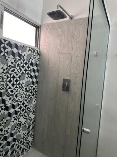 a shower with a glass door in a bathroom at MID-498 Centro in Mérida