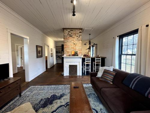 a living room with a couch and a fireplace at Renovated Mill House in Historic Golden Belt in Durham