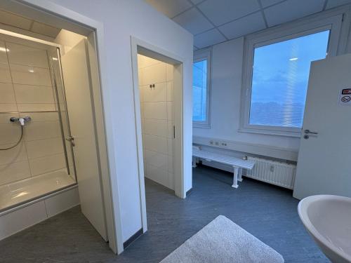 a bathroom with a sink and a toilet and a window at Thuja Apartments Karlsruhe-Neureut by KurzZeit in Karlsruhe