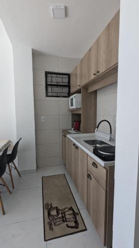 a kitchen with a sink and a counter top at RESIDENCIAL PORTAL DO SOL in Bombinhas