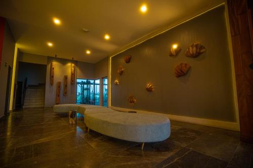 a room with a couch and some shells on the wall at Aloha Mazatlan in Mazatlán