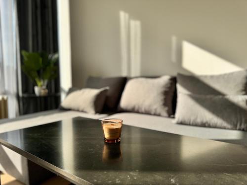a glass sitting on a table in a living room at LUYS Apartment in Brussels