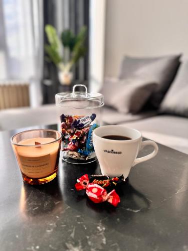 two cups of coffee and candy on a table at LUYS Apartment in Brussels