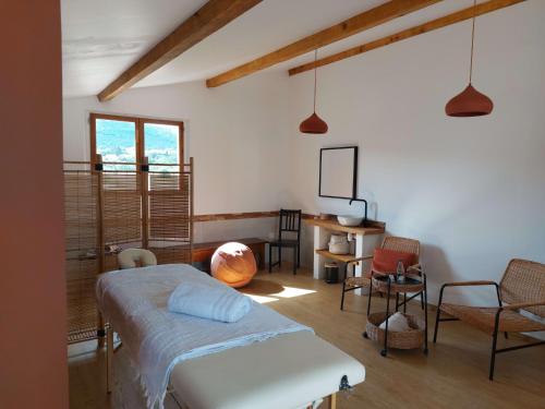 une chambre avec un lit, une table et des chaises dans l'établissement Chambres d'hôtes, B&B La Musardière, à Alba-la-Romaine