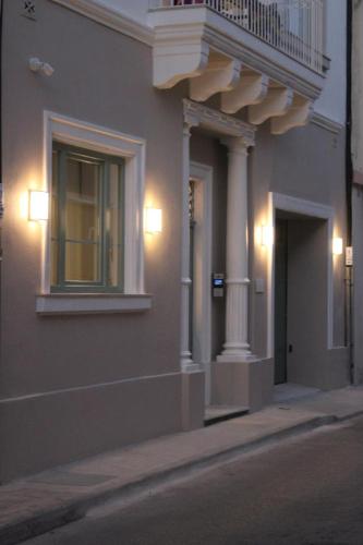 a building with a balcony and lights on a street at North Lodge by PetitChic in Mellieħa