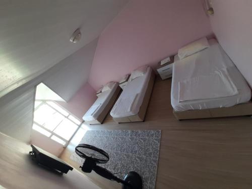 an overhead view of a bedroom with two beds and a rug at Balcı Apartment in Eceabat