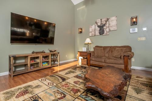 a living room with a couch and a flat screen tv at License to Chill in Swanton