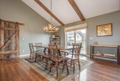 a dining room with a wooden table and chairs at License to Chill in Swanton
