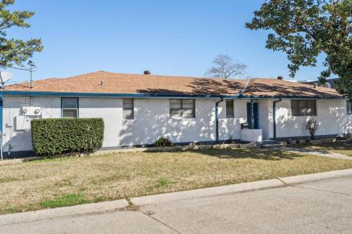 a white house with a brown roof at NOLA (3Bd) hub in Metairie