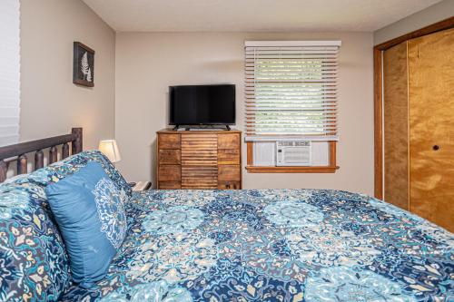 a bedroom with a bed and a flat screen tv at Laurel Ridge in McHenry