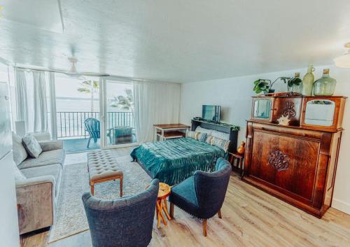a bedroom with a bed and a living room at Luxury Beachfront Condo in Hauula