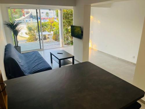 un salon avec une table et un canapé dans l'établissement Villa T2, île de la marina, climatisée, au Cap d'Agde