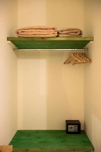 a room with two shelves and a clock on a wall at Nas Mar & Twins - Aristea in Petrití