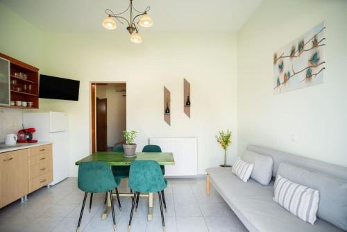a living room with a couch and a table at Nas Mar & Twins - Aristea in Petrití