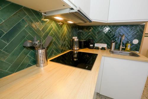 une cuisine avec un évier et un plan de travail dans l'établissement Cosy studio au centre du vieux Nice, à Nice