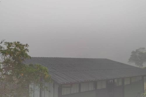 a house with a black roof in the fog at Colina Panzani in Ratones