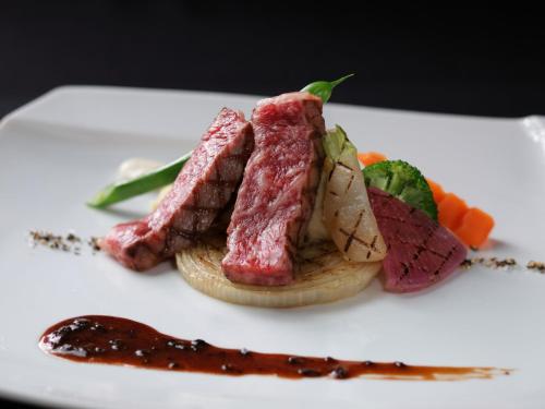 a plate of food with meat and vegetables on it at ANA Crowne Plaza Narita by IHG in Narita