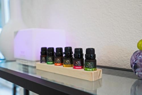 four bottles of essential oils sitting on a counter at Sage House Modern Retreat 3 Kings, Theater, Gmrm! in Sedona