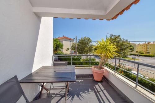 a balcony with a table and a potted plant at Estoril Prime Stay (Private Garden) beach 1km in Estoril