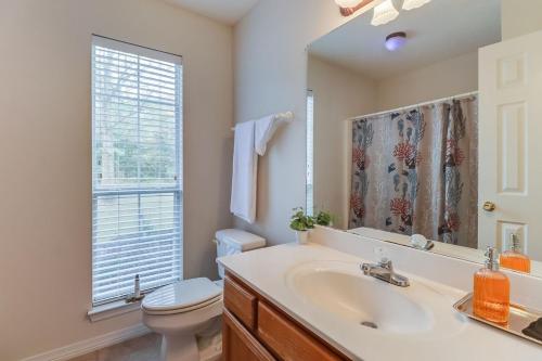 a bathroom with a sink and a toilet and a mirror at Relax In Your Private Paradise in Ocean Springs