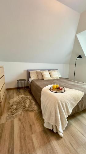 a bedroom with a bed with a tray of food on it at Stylowe apartamenty in Charzykowy