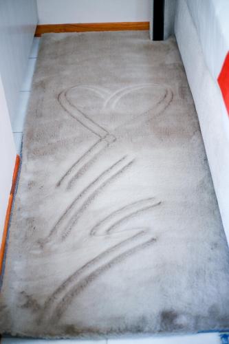 a mattress with a heart drawn on it at JTown CBD Self-Catering Apartment in Jwaneng