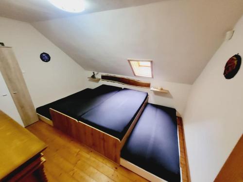 a small room with a bed in a attic at Dračí doupě in Loubí