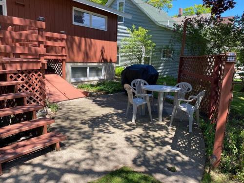 a patio with a table and chairs and a fence at New! Namaste Here - Incredible Location! in Frankfort