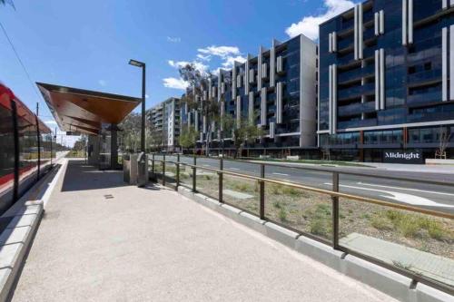 a sidewalk next to a street with a building at Midnight Luxe 2BR 2Bath 2Car 528 in the heart of Braddon Pool Sauna Gym Secure Parking Wifi Wine in Canberra