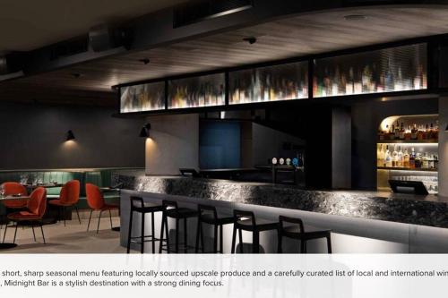 a restaurant with a bar with stools at Midnight Luxe 2BR 2Bath 2Car 528 in the heart of Braddon Pool Sauna Gym Secure Parking Wifi Wine in Canberra