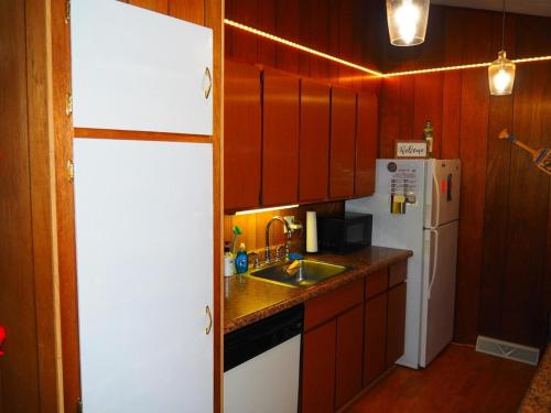 a kitchen with a white refrigerator and a sink at New! Namaste Here - Incredible Location! in Frankfort
