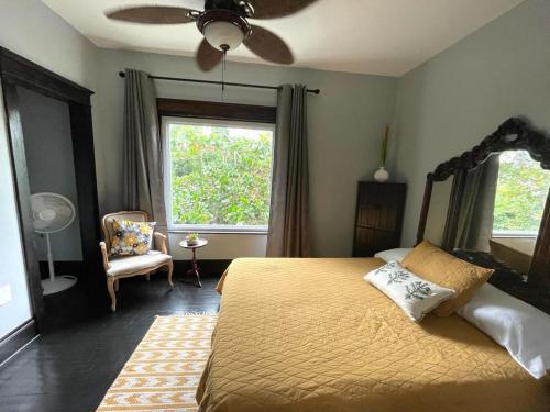 a bedroom with a bed and a chair and a window at Heavenly Suite in Little Havana Free Parking in Miami