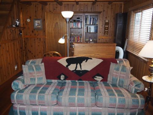 a living room with a horse blanket on a couch at The Crystalaire Cabin - Charming And Relaxing! in Frankfort