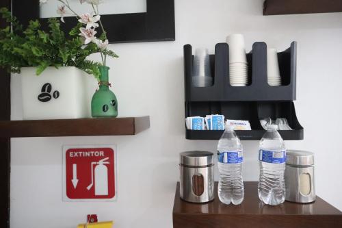a bathroom with two bottles of water on a counter at Posada Del Carmen Aguascalientes in Aguascalientes