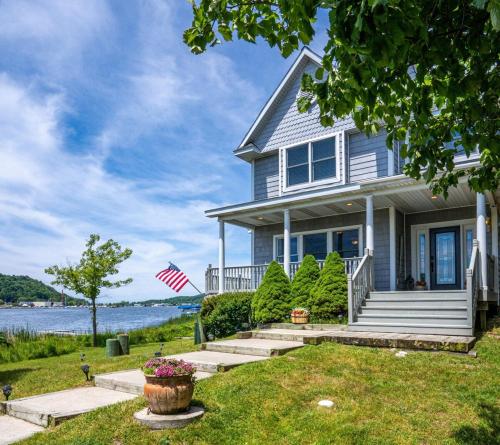 a house with a view of the water at Sunset Bay - Lakefront, Large, And Gorgeous! in Frankfort