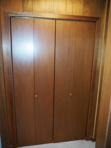 a closet with wooden cabinets in a room at New! Namaste Here - Incredible Location! in Frankfort