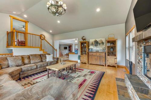 a living room with a couch and a fireplace at 2 Mi to Downtown Home with Hot Tub in Estes Park! in Estes Park