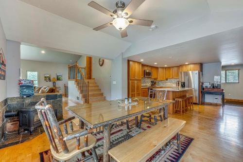 a living room with a dining table and a kitchen at 2 Mi to Downtown Home with Hot Tub in Estes Park! in Estes Park