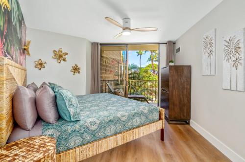 a bedroom with a bed and a balcony at Hip Hawaiian Oceanfront Vistas in Kihei