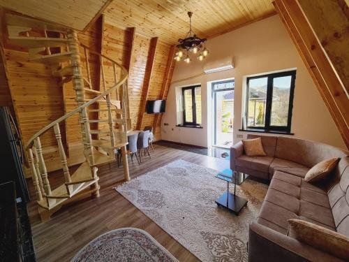 a living room with a staircase and a couch at Aframe Heating pool FrD in Gabala
