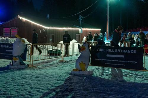 two stuffed animals are standing next to a sign at Mt Air Motel in Mount Hood Village