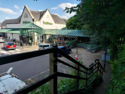 a building with a fence in front of a street at Jasmine cottage-1 King bed room, 40 mins to Cotswolds 90 mins to Oxford and Bath in Great Malvern