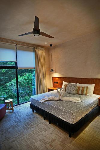 a bedroom with a large bed with a large window at Luxury 5-br Oasis Golf, Private Pool, Beach! in Akumal