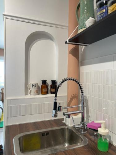 a kitchen sink with a faucet in a kitchen at Splendide Studio très proche gare - 16min Champs-Élysées in Sartrouville